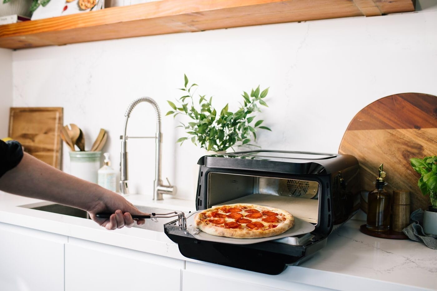 image:imageFrigidaire Electric Indoor Pizza Oven Reach Temperatures of 700F Stone Bake 12 Pizzas in Minutes Portable Countertop Oven with Air Fry and Bake Peel Included Model FRPO100BWith Pizza Peel Pizza Cutter